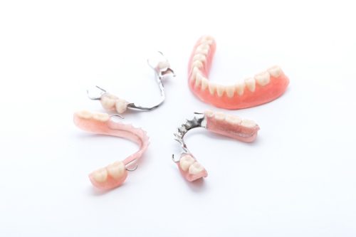 Set of dentures on white background